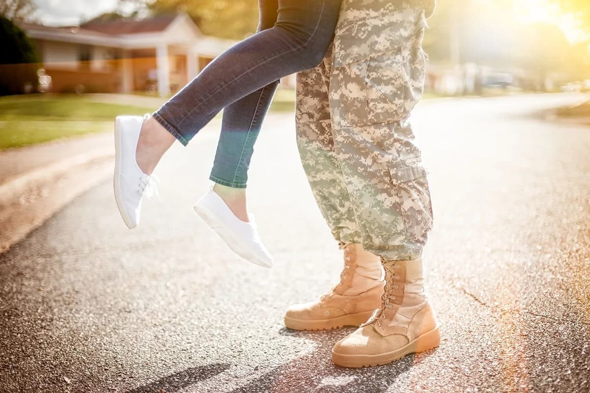 Young military couple kissing each other, homecoming concept, wa