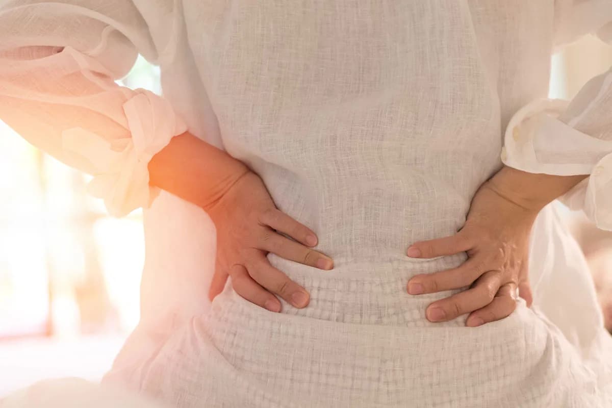 Back pain in woman concept. Female patient hurt from lower backa