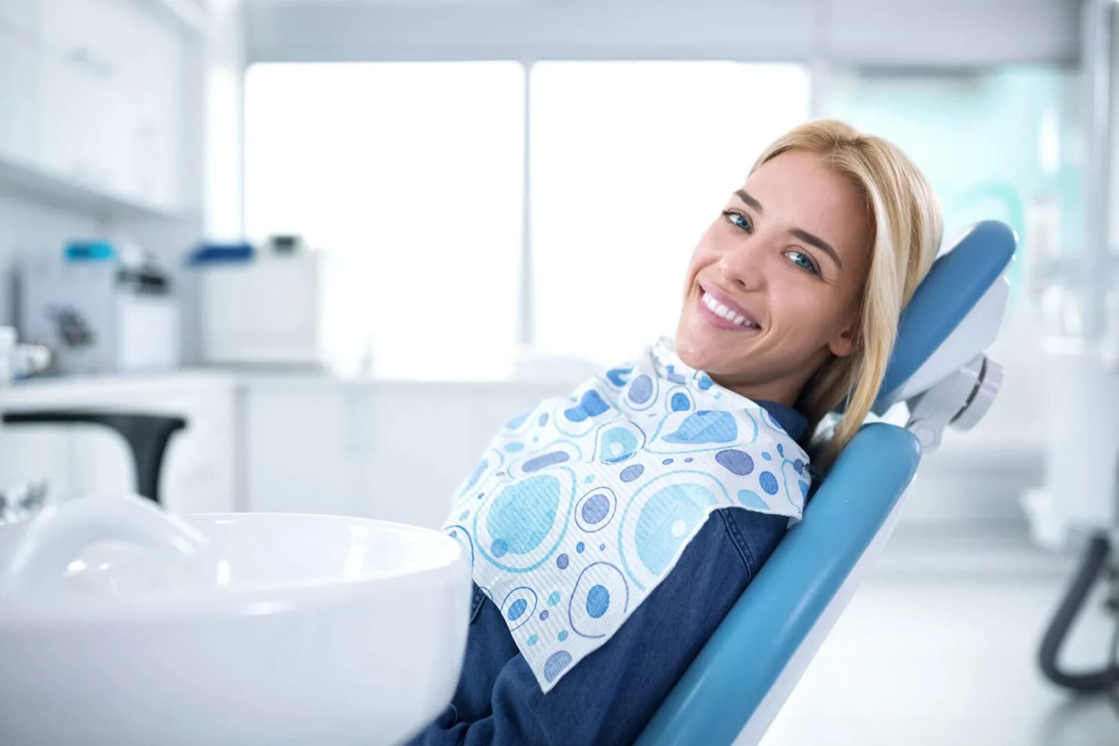 Smiling and satisfied patient in a dental office