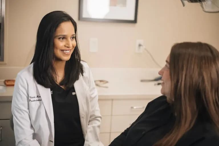 Dr. Vrinda Mohunta talks with a patient at ClearChoice Dental Implant Center in The Woodlands.