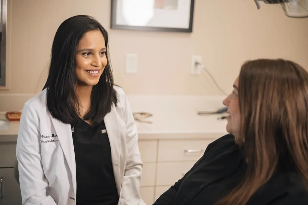 Dr. Vrinda Mohunta talks with a patient at ClearChoice Dental Implant Center in The Woodlands.