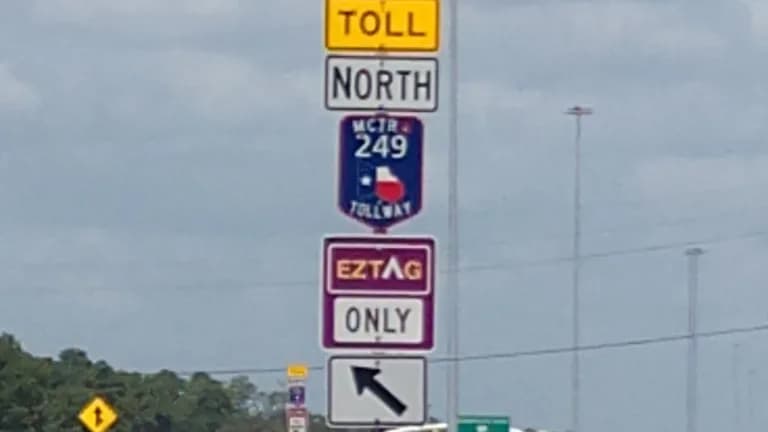Toll and EZ TAG signs at the entrance to the northbound SH 249 tollway from Decker Prairie and Hardin Store roads in Pinehurst