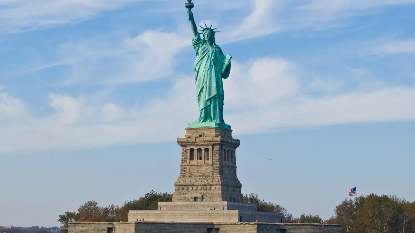 The Statue of Liberty on Liberty Island under a blue sky