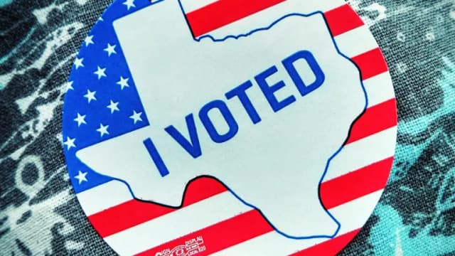 An I Voted sticker shaped like Texas