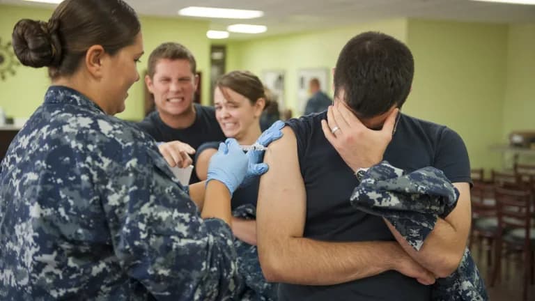A patient receives a flu shot at Naval Health Clinic Corpus Christi
