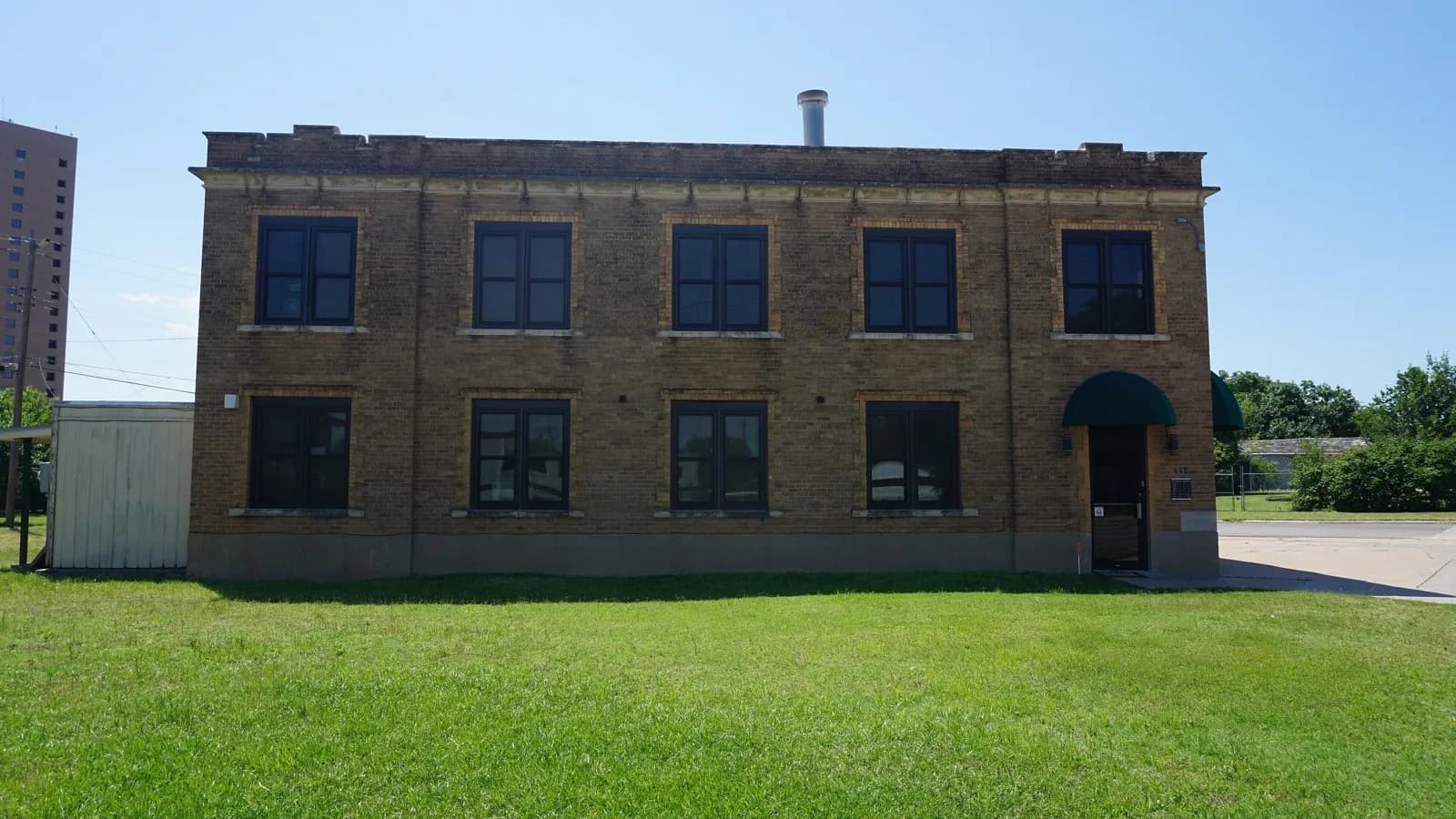Abilene's former Fire Station No. 2, a two-story tan brick building on a green lawn