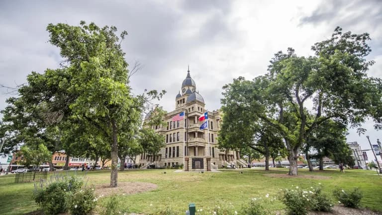 The Denton County Courthouse-on-the-Square, a domed stone building framed by large trees