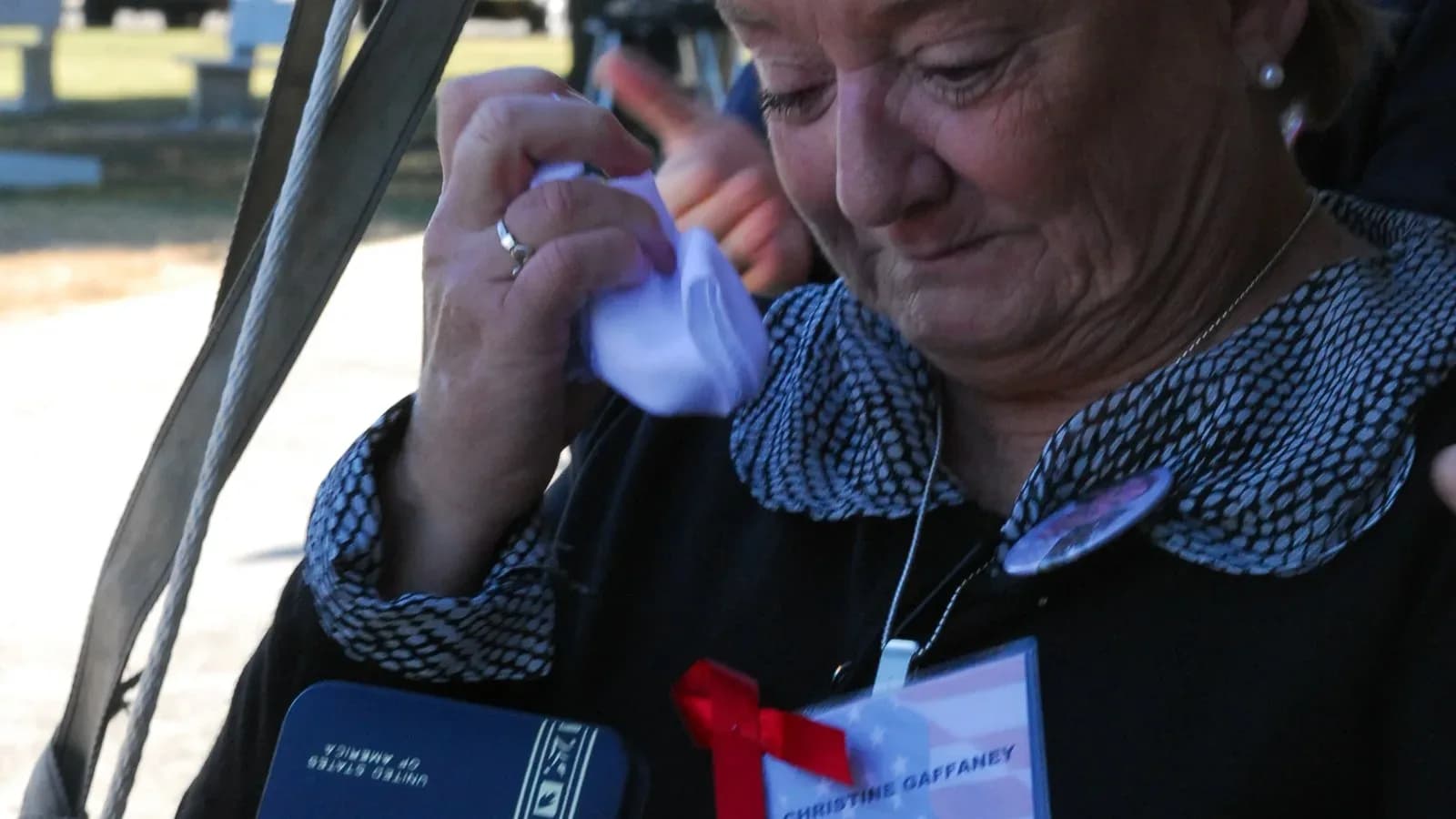 A widow wipes tears from her eyes at a Fort Hood memorial ceremony