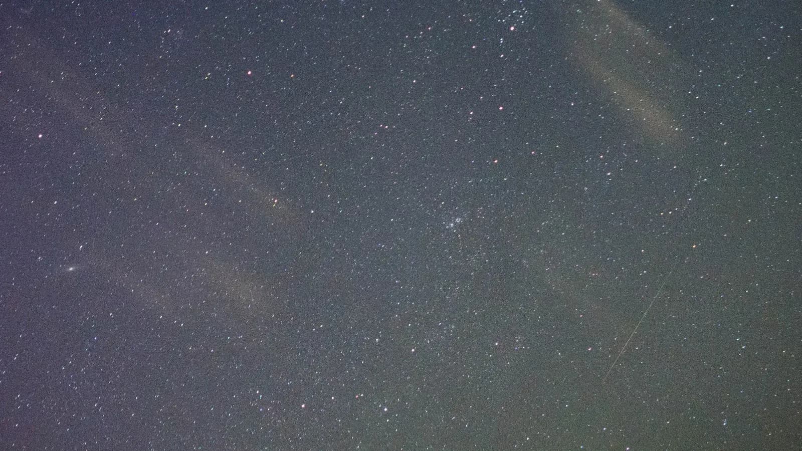 An Orionid meteor streaking across a starry night sky