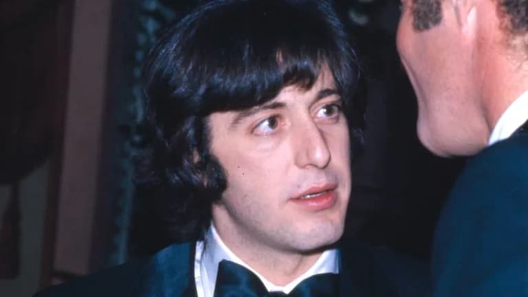 A young Al Pacino in a tuxedo and bow tie speaking with James Caan