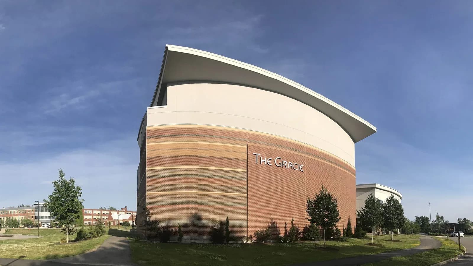 The Gracie Theatre, a curved brick building at Husson University in Bangor, Maine