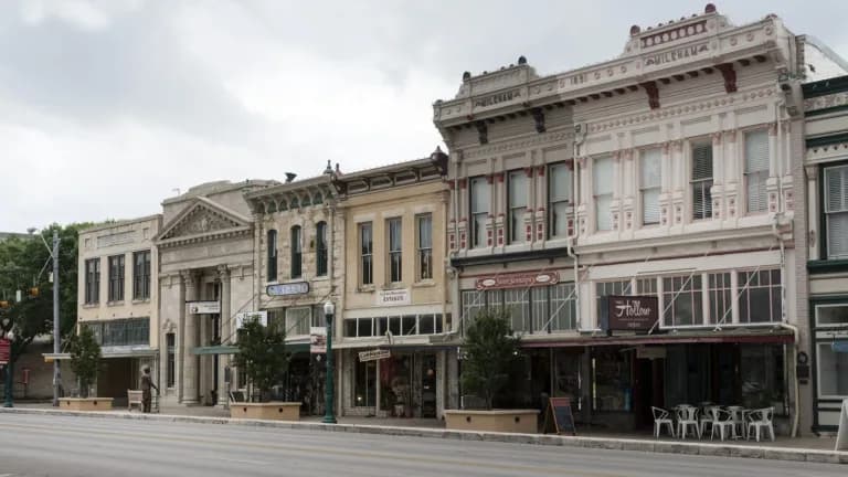 A row of restored two-story Victorian commercial buildings with ornate cornices on the Georgetown courthouse square