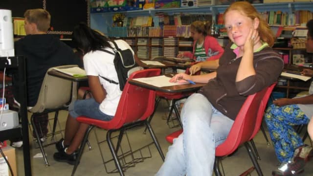 Students working at desks in a classroom