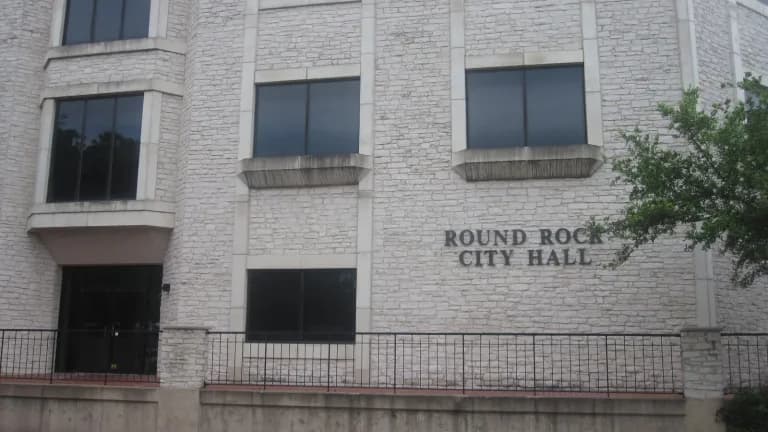The stone front of Round Rock City Hall with its name lettered on the wall