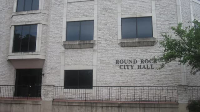 The stone front of Round Rock City Hall with its name lettered on the wall