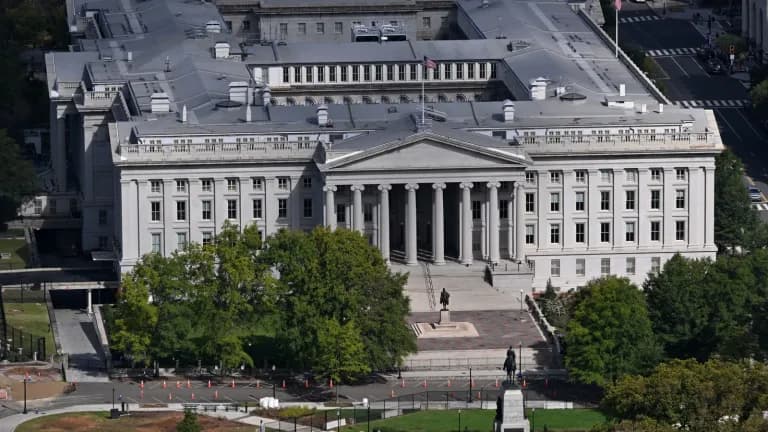 Aerial view of the columned U.S. Treasury Department building in Washington with a statue of General Sherman in front
