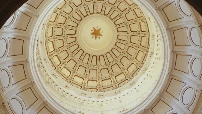 Looking straight up into the inside of the Texas Capitol dome, with a gold star at its center