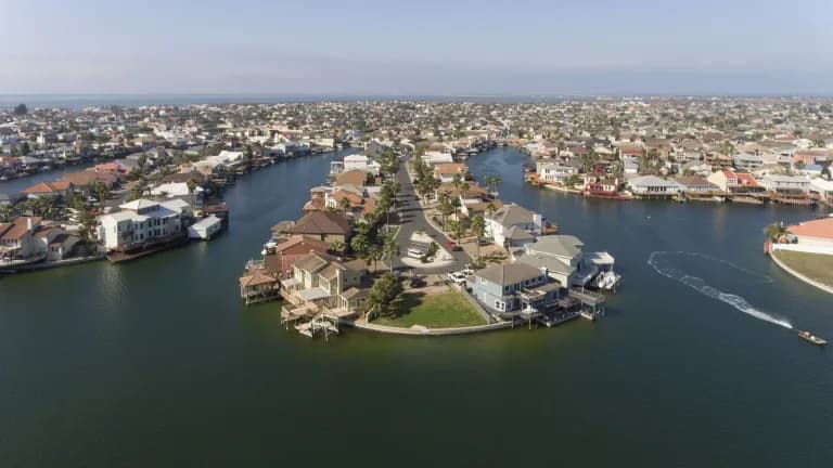Aerial view of waterfront homes along canals in a residential neighborhood on Padre Island, Texas