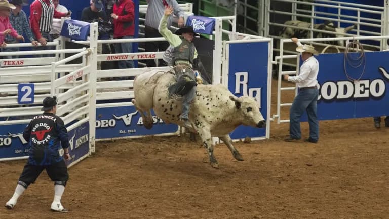 A bull rider holds on during the bull riding event at Rodeo Austin