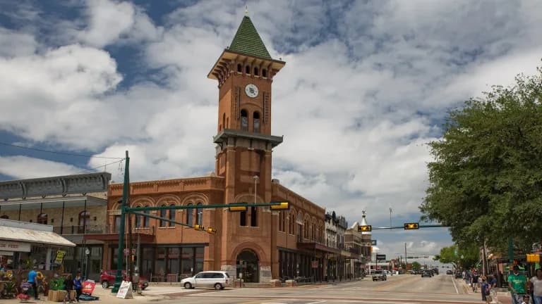 Brick clock tower of the visitor information center rising over Main Street in downtown Grapevine