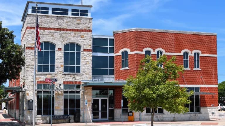 Kyle City Hall, a modern building with a tower entrance, under a clear sky