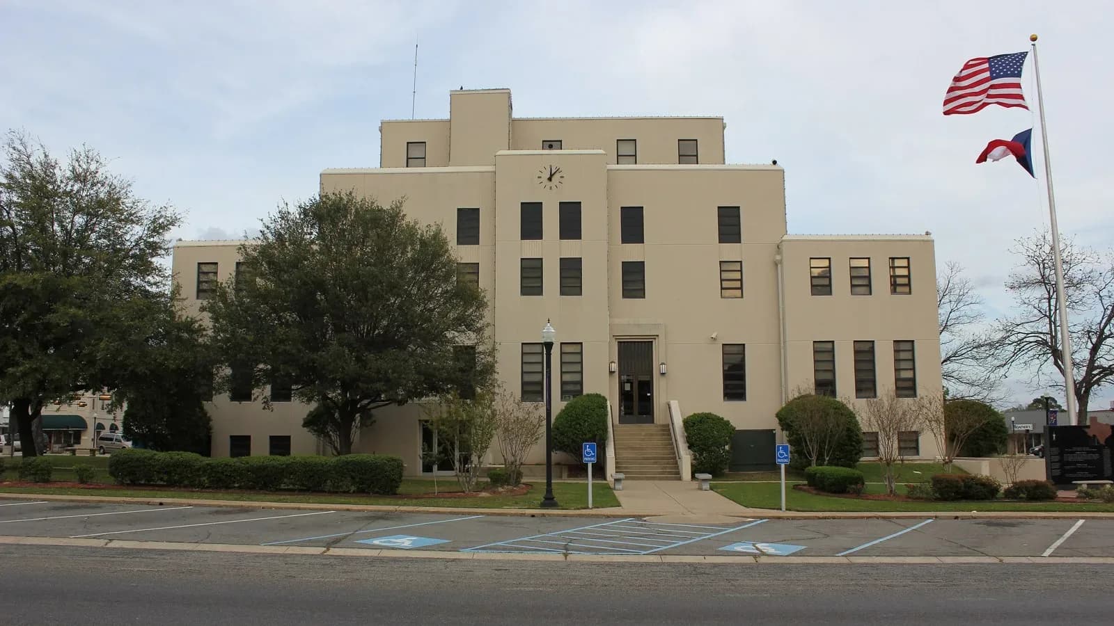 Titus County Courthouse in Mount Pleasant, Texas, a tan stone building with a clock