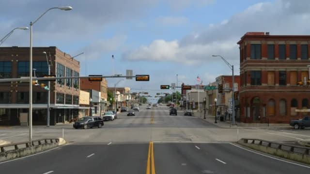 Historic brick buildings lining a street in downtown Taylor, Texas