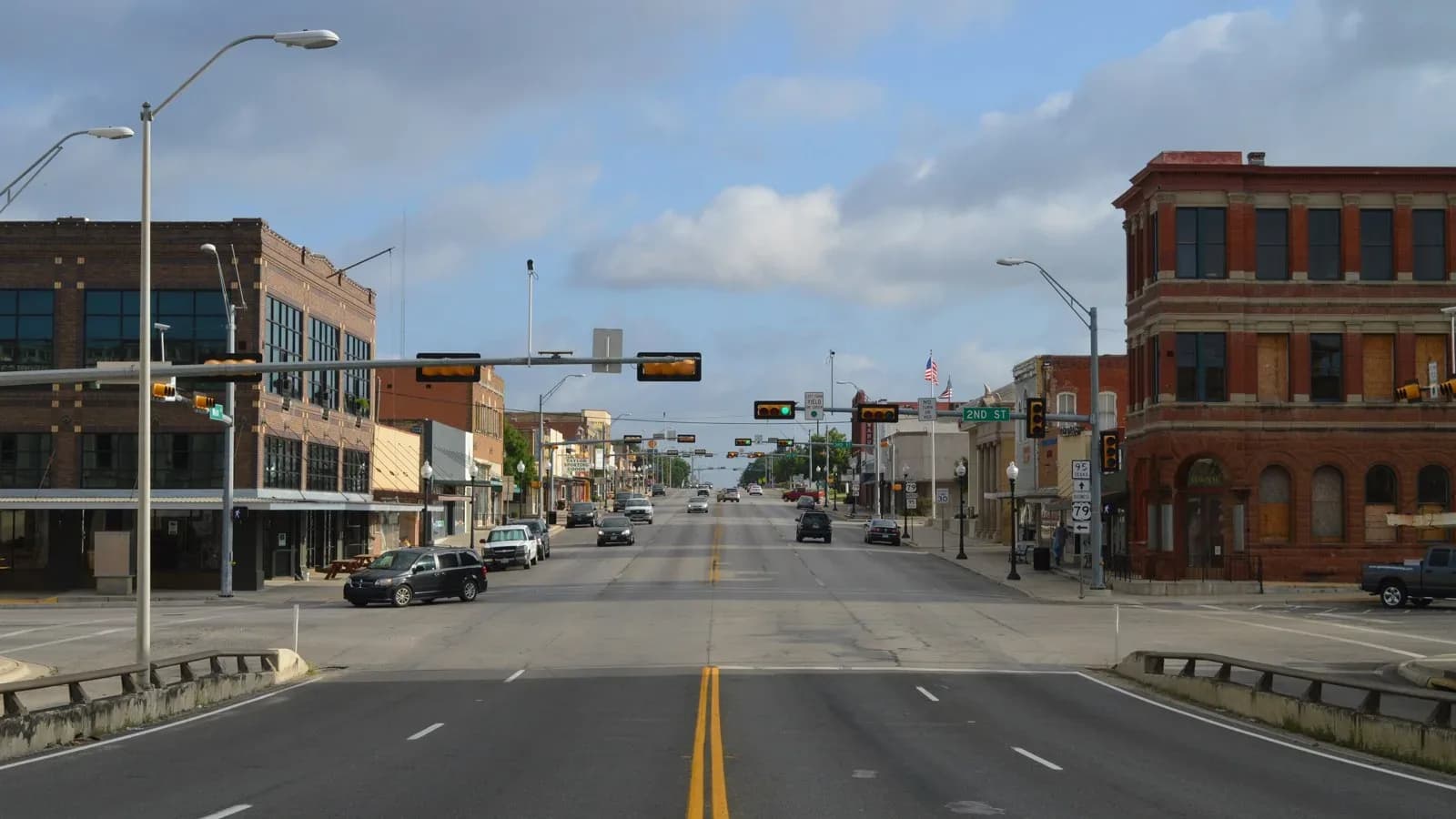 Historic brick buildings lining a street in downtown Taylor, Texas