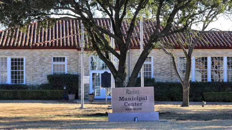 The Rowlett Municipal Building, a brick building with a flagpole out front