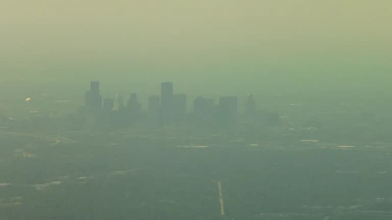 Downtown Houston skyscrapers seen through a brown haze of smog