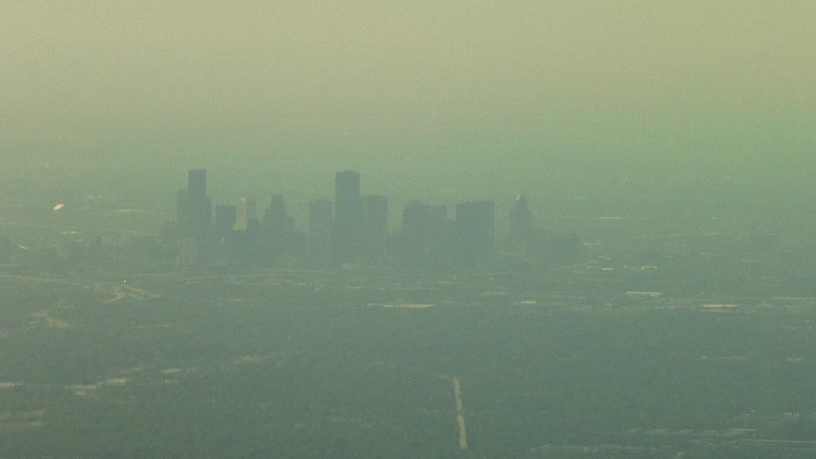 Downtown Houston skyscrapers seen through a brown haze of smog