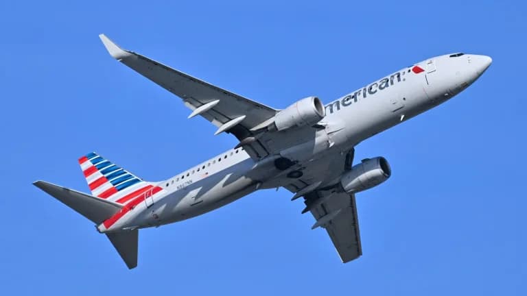 An American Airlines Boeing 737-800 climbing against a clear blue sky