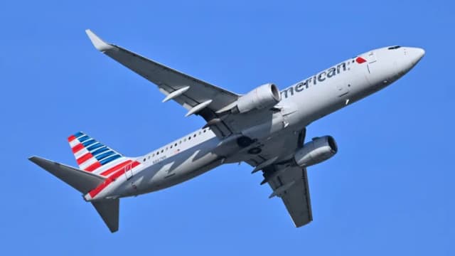 An American Airlines Boeing 737-800 climbing against a clear blue sky