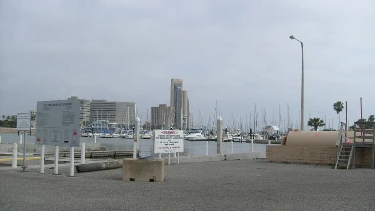 Boats in the harbor along the Corpus Christi bayfront with downtown buildings behind