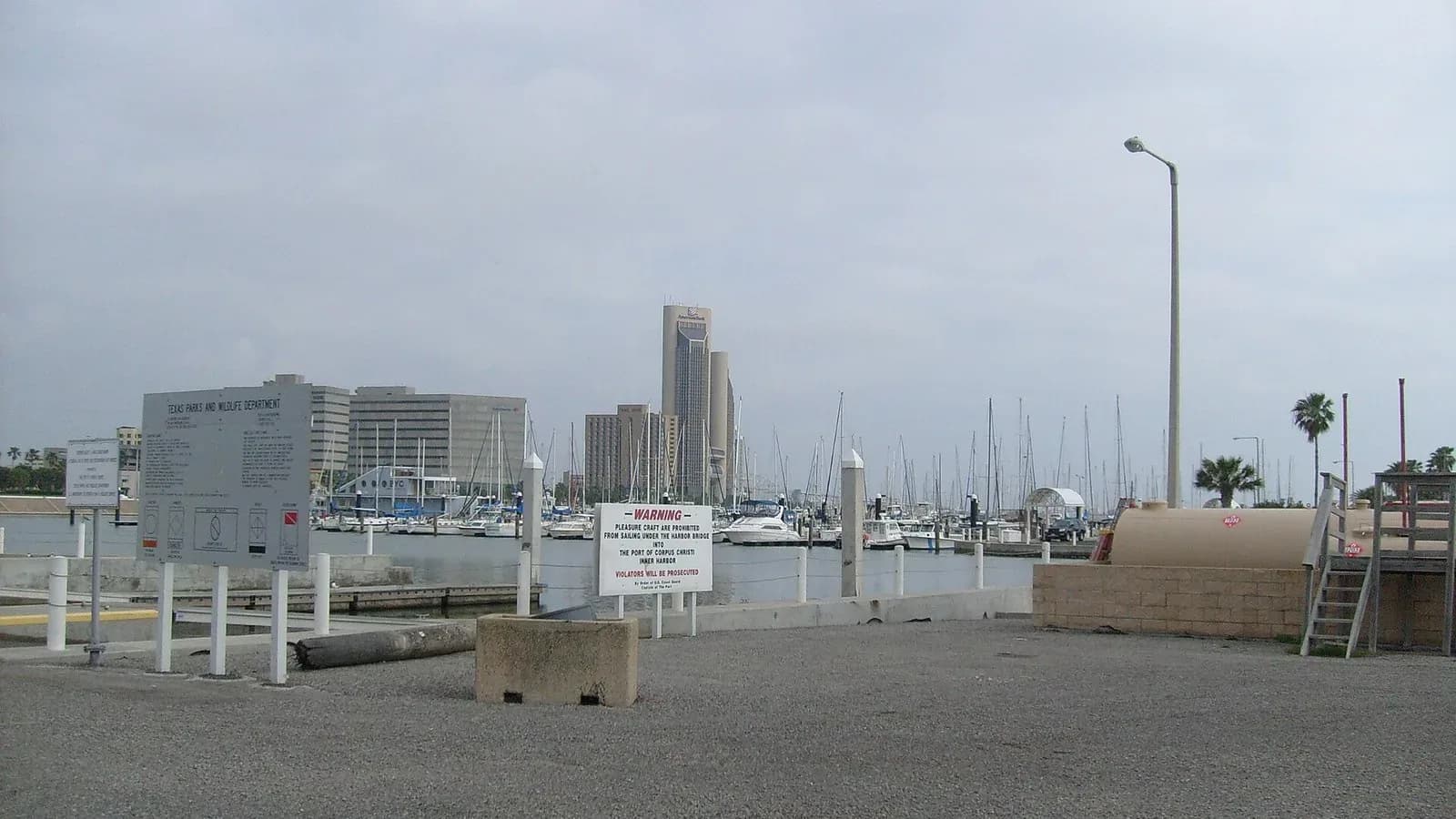 Boats in the harbor along the Corpus Christi bayfront with downtown buildings behind