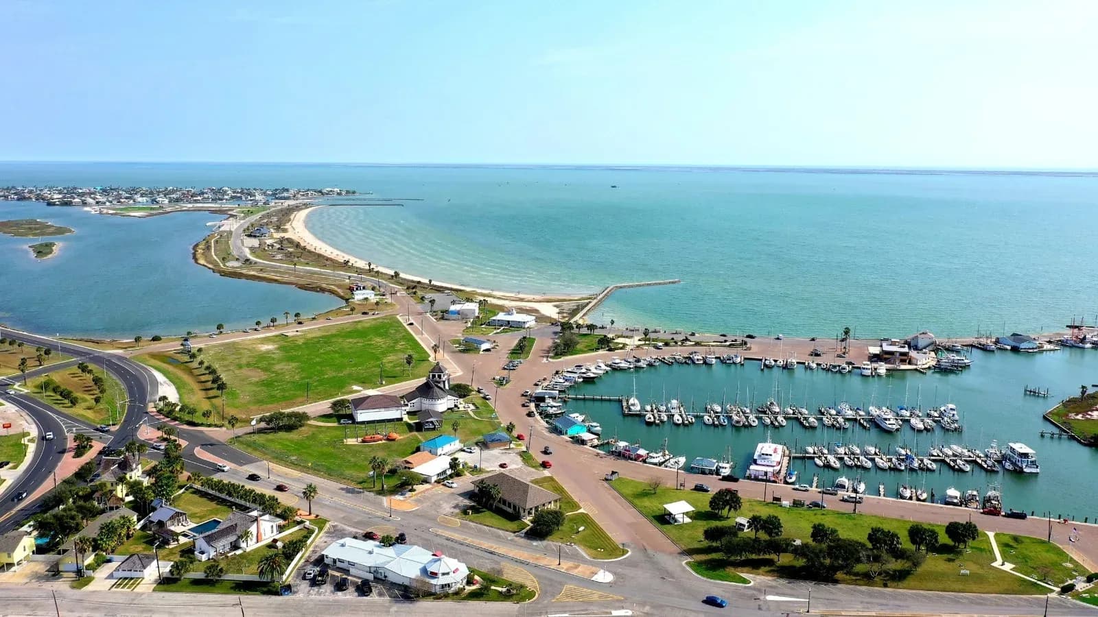 Aerial view of the Rockport, Texas, waterfront with a marina and beach on Aransas Bay