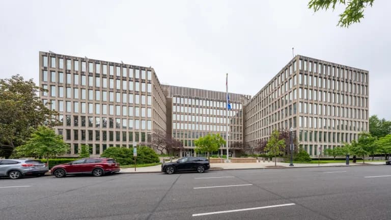 The Theodore Roosevelt Federal Building in Washington, headquarters of the U.S. Office of Personnel Management, with a flagpole out front