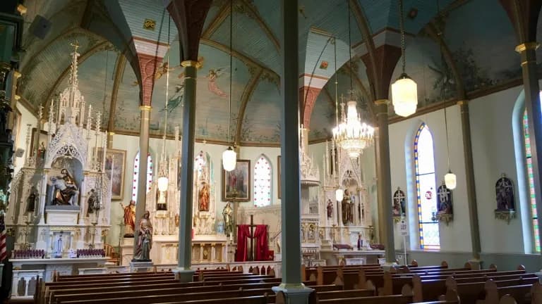 The painted blue ceiling, columns and altar inside St. Mary's Church of the Assumption in Praha, Texas