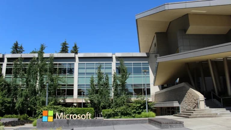 Building 92 on Microsoft's headquarters campus in Redmond, Washington, with the Microsoft logo sign in front