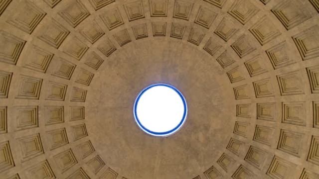 The coffered concrete dome of the Pantheon in Rome seen from below, with daylight through the central oculus