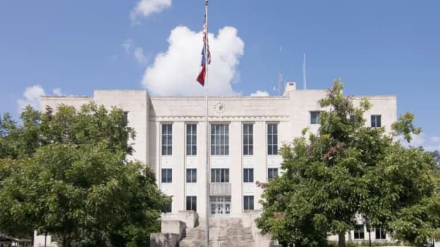 The Brazoria County Courthouse in Angleton, Texas, under a blue sky