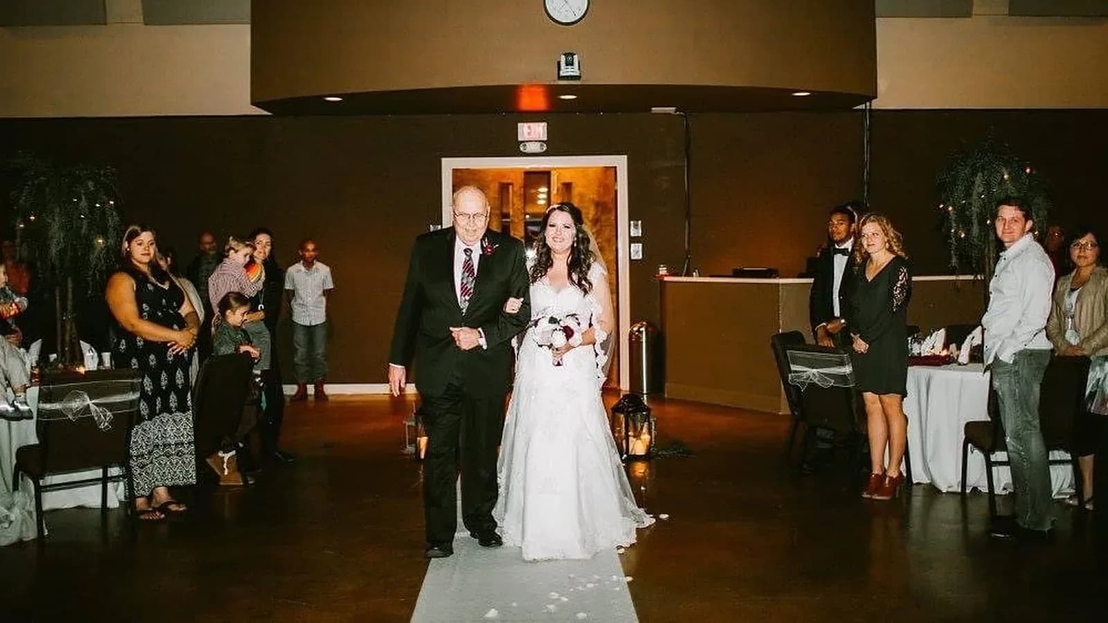 Gerald Mounce walking his granddaughter Megan down the aisle on her wedding day