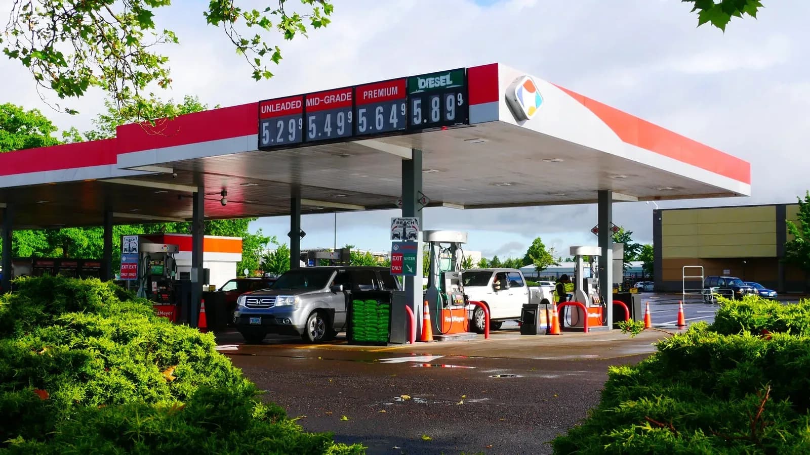 Gas station canopy with a price sign showing unleaded, mid-grade, premium and diesel prices