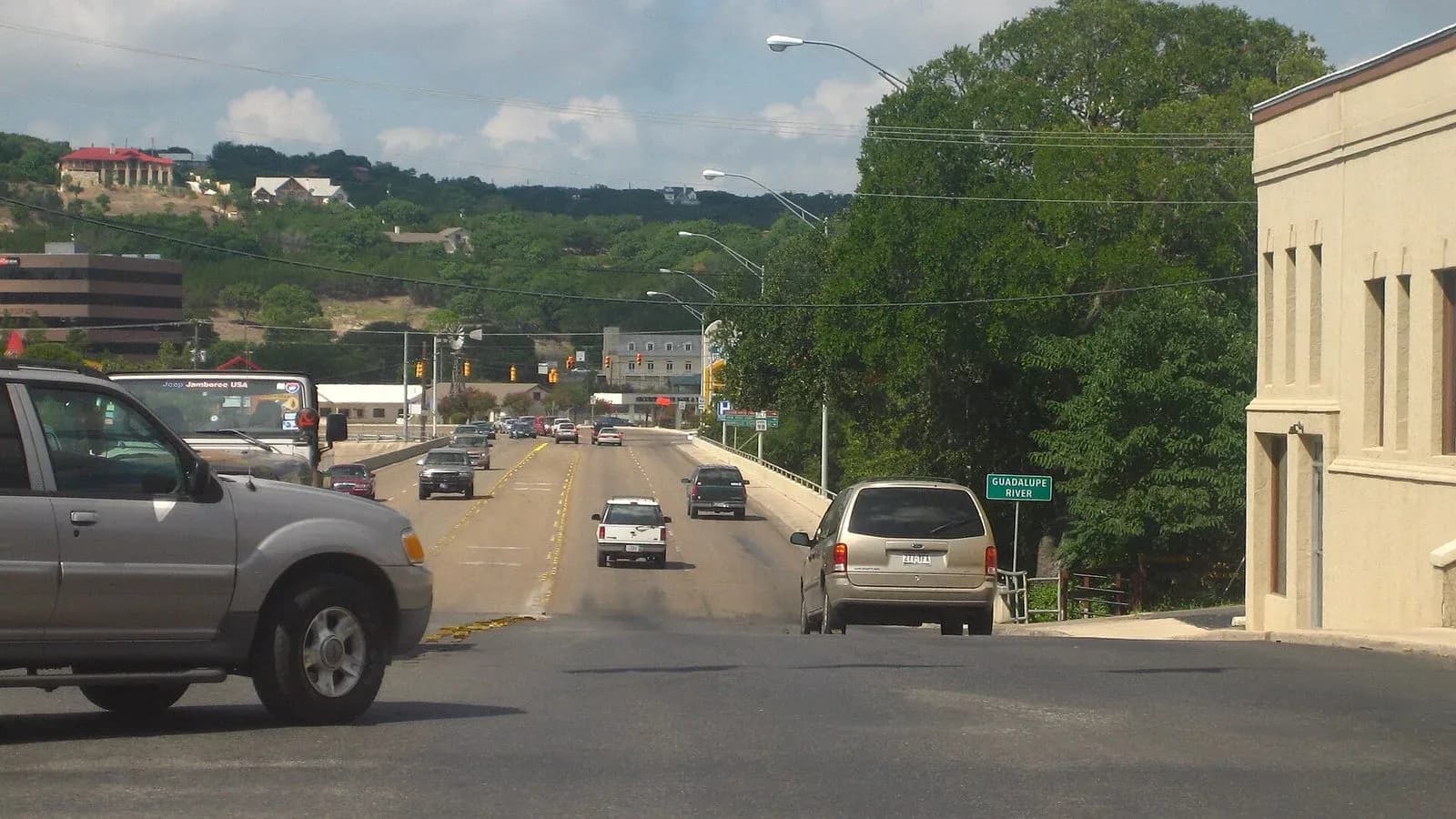 Traffic crossing a street bridge over the Guadalupe River in Kerrville