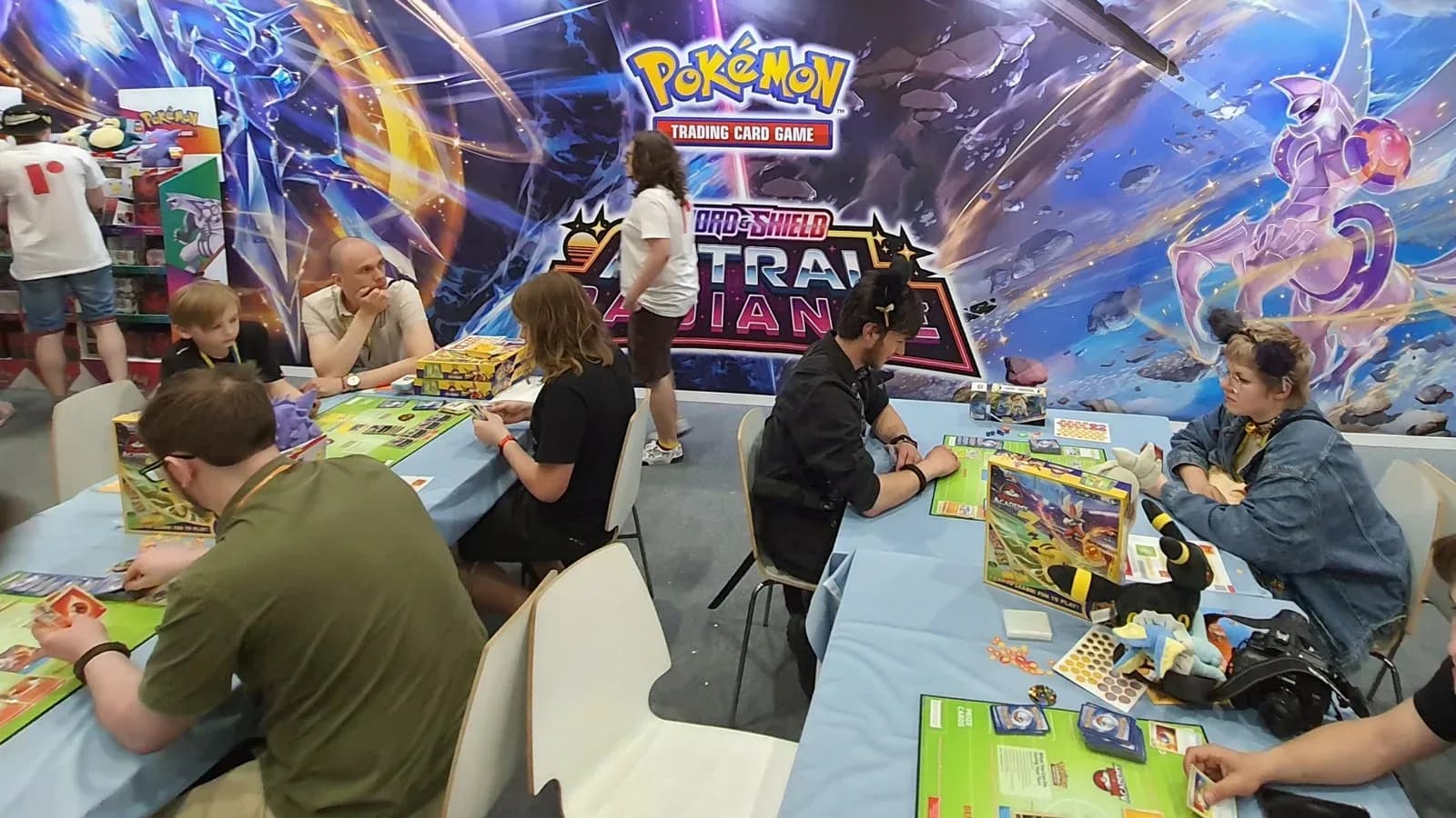 Players at tables during a Pokémon Trading Card Game event (illustrative)