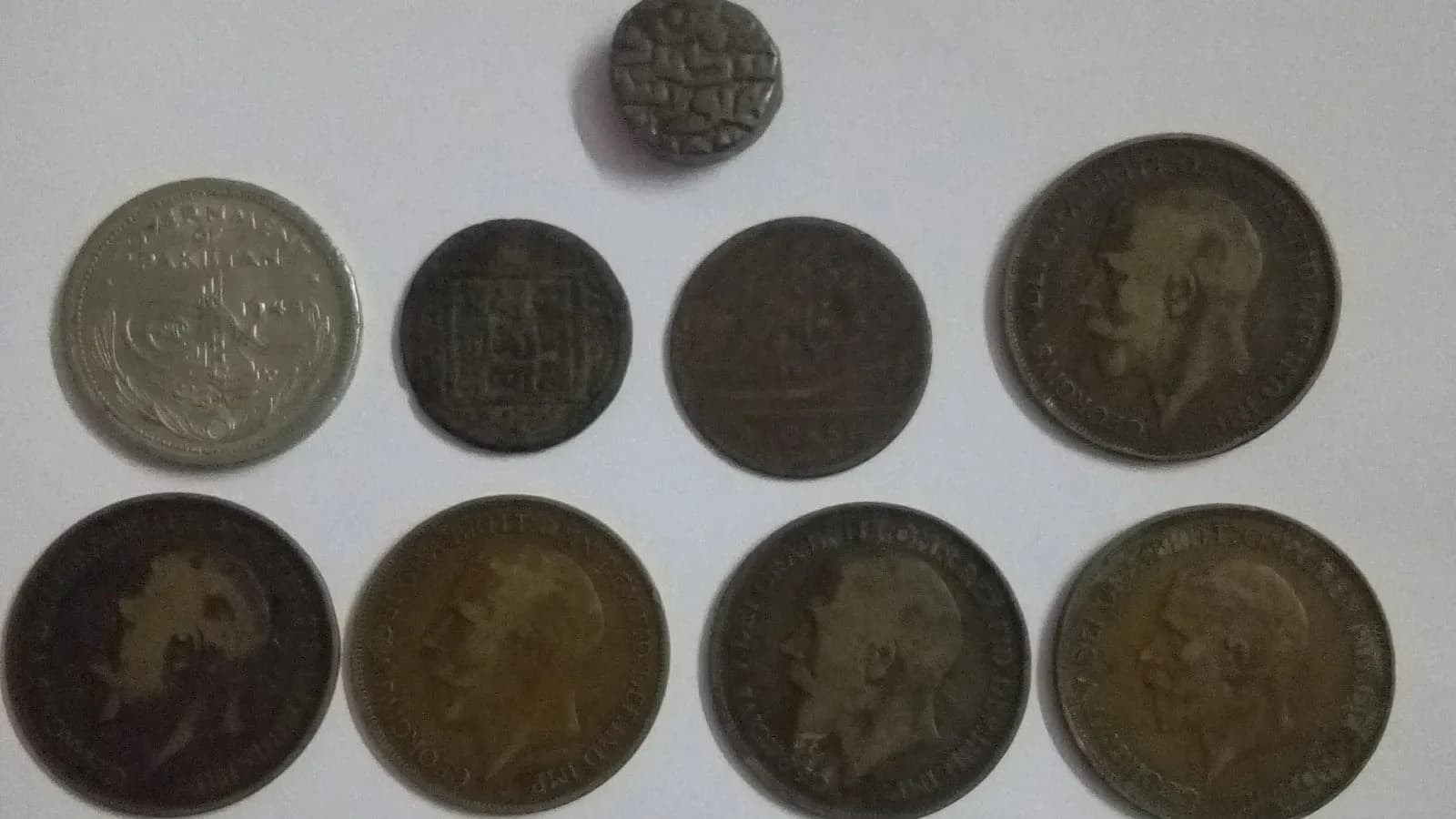 Old coins laid out from a numismatic collection (illustrative)