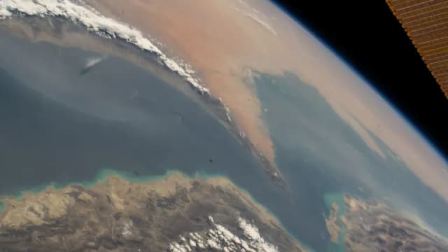 The Strait of Hormuz seen from the International Space Station, with Iran below and the Arabian Peninsula beyond