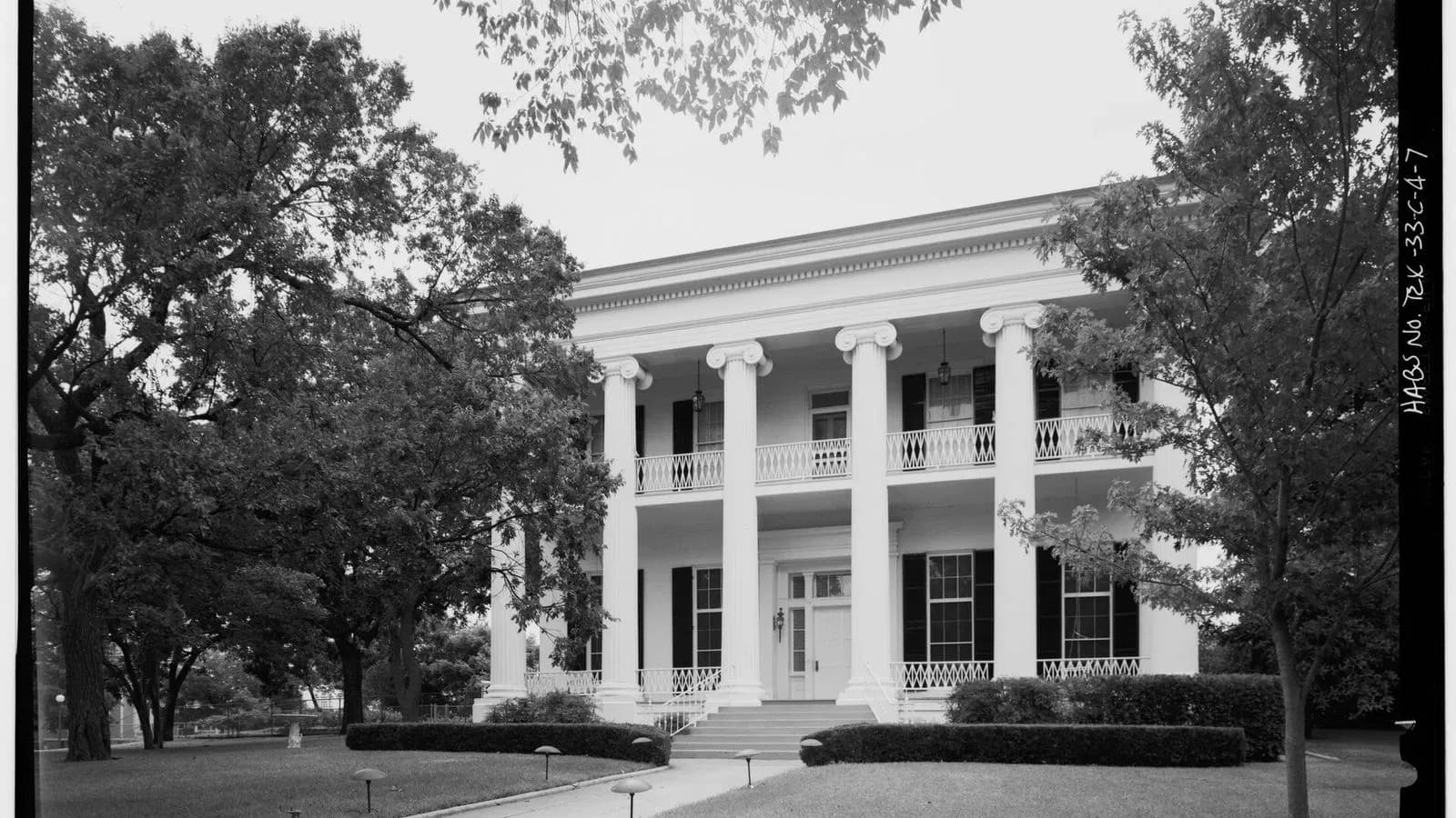 The white-columned Texas Governor's Mansion framed by oak trees