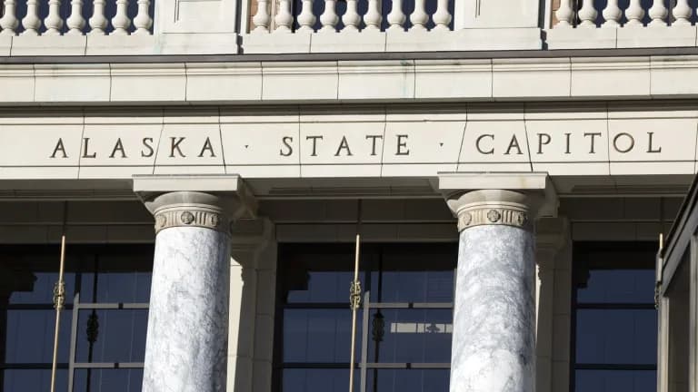 The words Alaska State Capitol carved above marble columns at the Capitol entrance in Juneau
