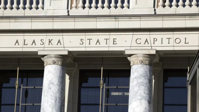 The words Alaska State Capitol carved above marble columns at the Capitol entrance in Juneau
